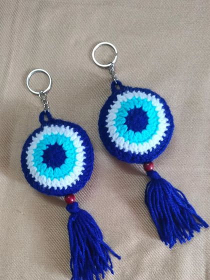 A pair of my crochet evil eye key rings. I make them with a tassel and a wooden bead. They are a popular design for bringing good luck and protection.
