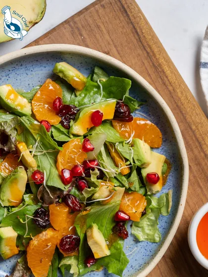 Every great meal needs a fresh start. This vibrant salad with oranges, avocado, cranberries, and pomegranate seeds is a beautiful and healthy addition to any buffet, offering a burst of freshness.