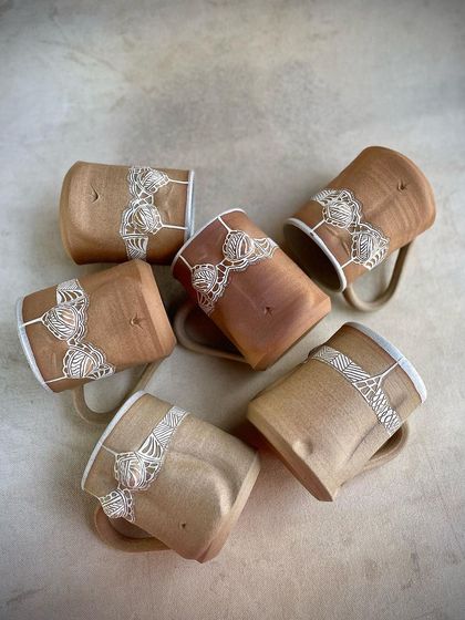 A group of 'Fiona' mugs from the Déesse collection, showing the subtle variations that come with handmade work. Each one has its own unique character.