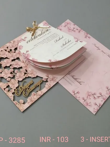 This unique invitation features a pink floral laser-cut cover that opens to reveal fan-shaped inserts. It's a playful and highly distinctive format that your guests will surely remember.