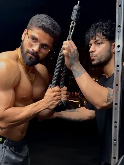 In the gym, making sure the form is perfect for tricep pushdowns. Every detail matters when you're aiming for a top-tier physique.