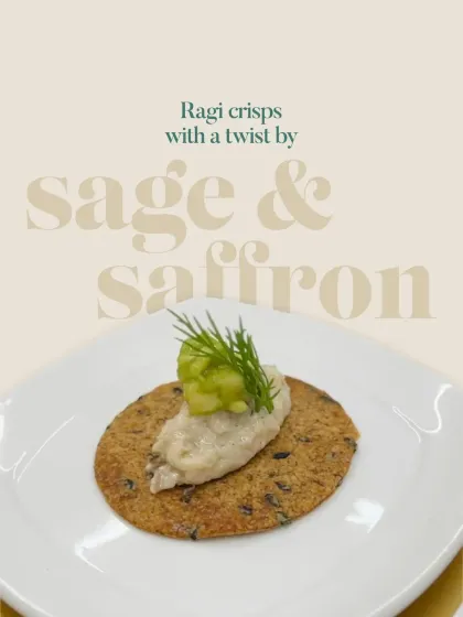 A simple yet elegant presentation of a ragi crisp topped with a creamy spread and garnished with fresh dill and cucumber. This highlights the versatility of the humble ragi crisp.