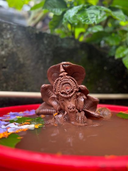 The Ganesha idol, now partially dissolved, returns to its elemental form. This is a powerful reminder of the cycle of creation and dissolution.