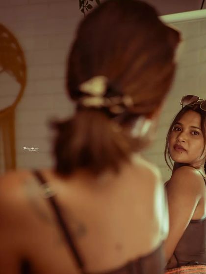 Using a mirror is a great way to create a story in a portrait. This shot feels like a private, behind-the-scenes moment.
