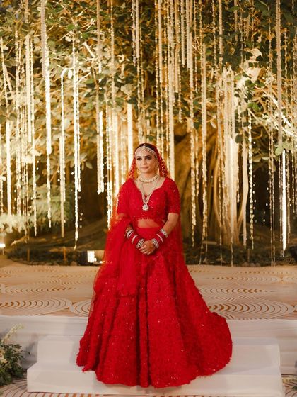 A full view of the bride on stage, where her makeup looks just as flawless from a distance as it does up close.