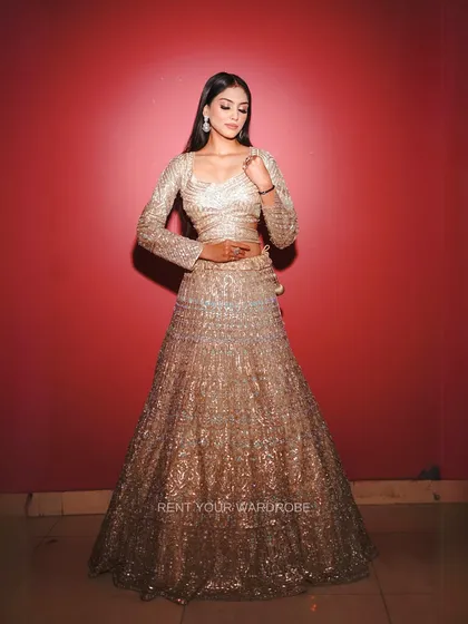A softer pose that highlights the flow of the bell sleeves and the shimmer of the sequins.