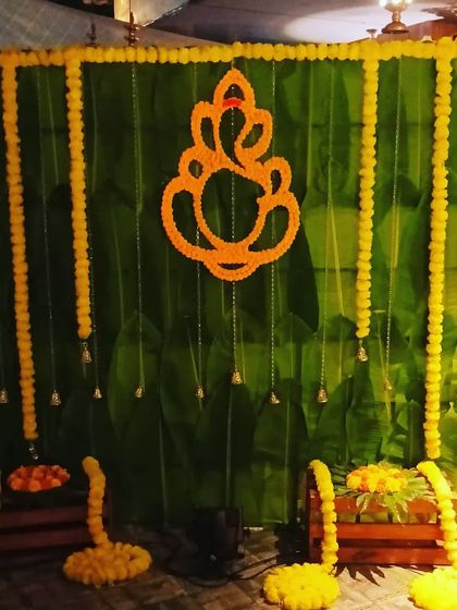 The same Onam decoration setup under normal lighting. This traditional design with a banana leaf backdrop and marigold flowers is also suitable for pujas or housewarming ceremonies.