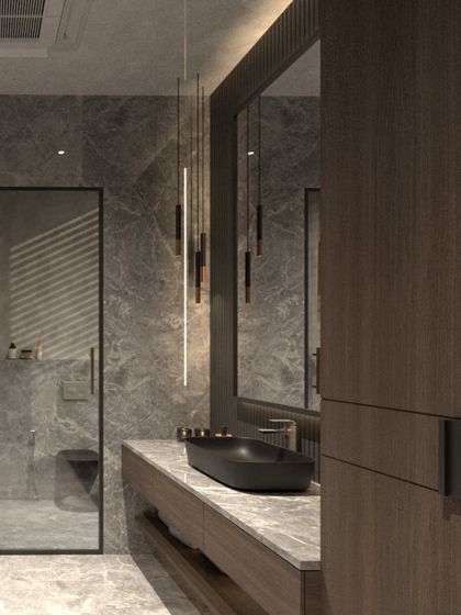 The bathroom in this moody villa concept features deep grey stone walls and a rich wood veneer vanity. A sleek black basin and minimalist pendant lights complete the modern, tactile, and comforting design.