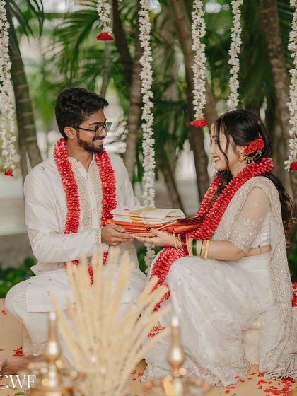 The ritual of exchanging gifts. Tamanna and Prem share a moment of connection during their serene white-themed wedding ceremony.