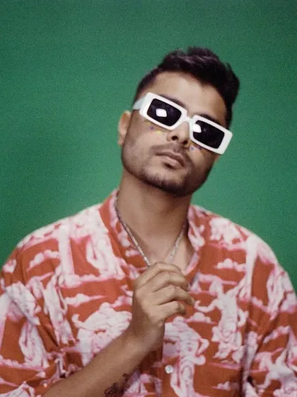 Styling for another artist on the 'UDD CHALEIN' project, creating a cool, casual look with a printed shirt and white-framed sunglasses.