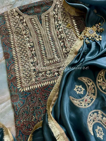A flat-lay composition of the kurta and dupatta, accessorized with traditional jewelry to highlight its festive and formal appeal.