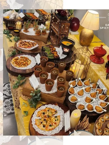 A beautiful Haldi-themed grazing table featuring a mix of Italian and Indian favorites. We included mini pizzas, samosas, and chaat cups, all presented on a vibrant yellow tablecloth to match the festive mood.