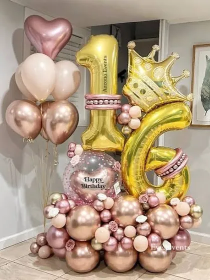 This "Sweet 16" balloon bouquet is fit for a princess. It includes large gold number balloons, a crown foil balloon, and a mix of rose gold, pink, and heart shaped balloons to celebrate the special milestone.