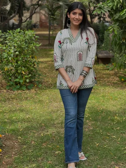A simple and fresh look for a casual festive gathering. This printed short kurta paired with classic blue jeans is a great example of comfortable and stylish fusion wear.