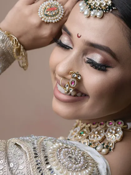 A happy, smiling shot that captures the success of the final look. The makeup is designed to look beautiful from every angle and in every expression.