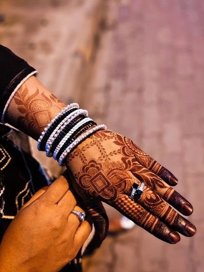 A close-up of the hand, showing the rich color and intricate details of the stain.