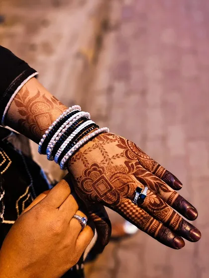A close-up of the hand, showing the rich color and intricate details of the stain.