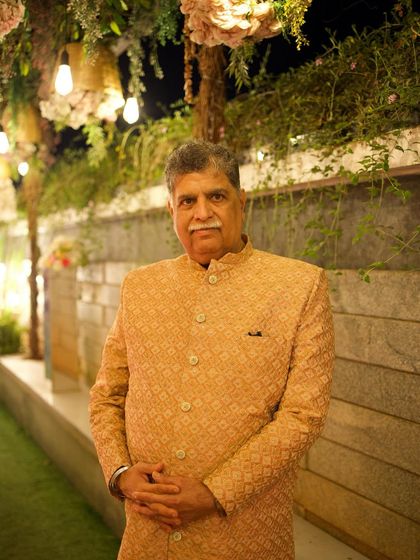 A client looking distinguished and elegant in a golden-beige bandhgala jacket. The subtle pattern and classic cut make this a perfect outfit for the father of the bride or groom, or any guest wanting a regal look.