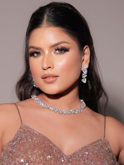 Another shot of this stunning glam look. The full view shows how the makeup complements the sparkling dress and diamond jewelry, creating a cohesive and glamorous style.