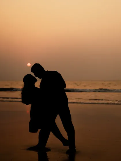A romantic silhouette of Hiresh and Apurva against the setting sun during their pre-wedding beach photoshoot. These artistic shots are perfect for creating timeless memories.
