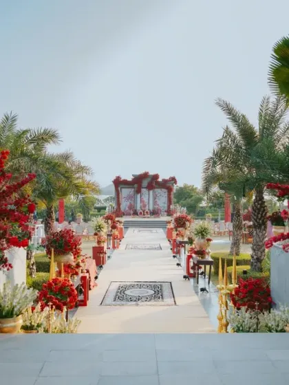 The wedding aisle, named 'Gulal Bagh', is lined with explosive bouquets of red florals, leading to a mandap that perfectly complements the palatial architecture. This shows how I use color to create a powerful and symbolic journey.