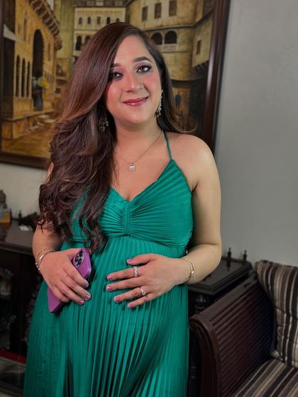 A happy portrait of the glowing mother-to-be. The makeup is minimal and fresh, designed to celebrate her natural beauty during this special time.