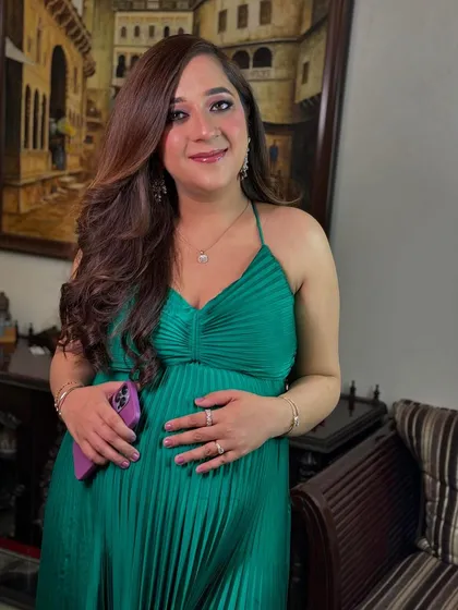 A happy portrait of the glowing mother-to-be. The makeup is minimal and fresh, designed to celebrate her natural beauty during this special time.
