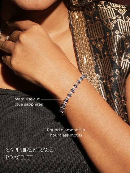The Sapphire Mirage Bracelet, worn to showcase its unique design. It features marquise-cut blue sapphires and round diamonds set in an elegant hourglass motif.