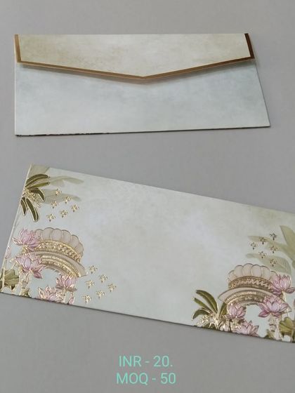 A simple and graceful money envelope with a light green, textured background. The design features subtle illustrations of traditional arches and lotus flowers in gold foil.