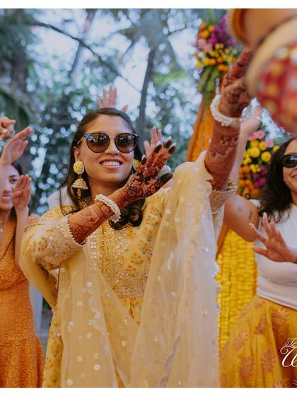 The bride and her bridesmaids enjoying the music at the Haldi. These are the moments of pure fun and friendship that make a wedding so special.
