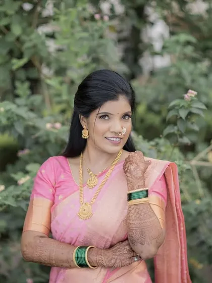 A close-up portrait capturing the bride-to-be's happy expression and traditional jewelry.