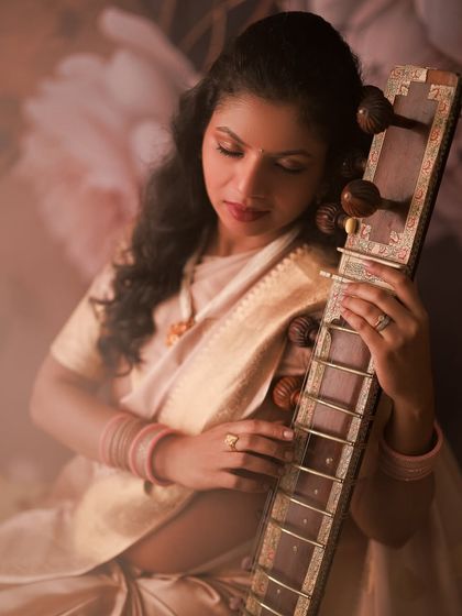 A serene moment with her sitar. This portrait is a beautiful blend of her passion for music and the magic of her maternity journey, creating something truly unique.