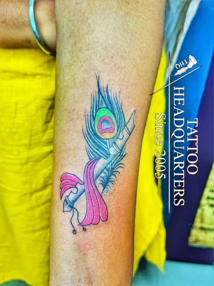 We also work with color to make your designs vibrant. This piece combines the spiritual symbolism of Krishna's flute and a peacock feather with bright, lasting color.