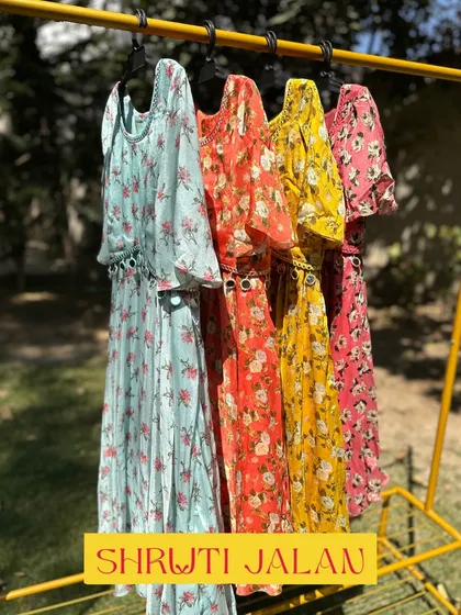 My floral dresses are perfect for summer parties. They come in a range of colors like aqua, orange, yellow, and pink, all with a delicate mirror-work belt.