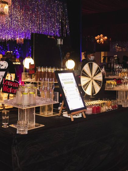 A sleek and modern bar setup for a cocktail party. This station includes a hangover-cure bar, a shots menu, and our interactive spin-the-wheel game.