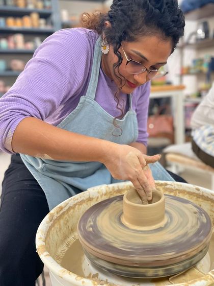 With gentle pressure and steady hands, a student begins to pull up the walls of a small cylinder. It's amazing to watch the form grow taller with each rotation.