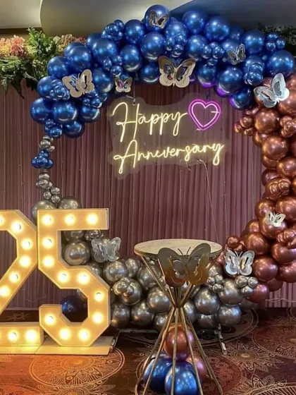 A duplicate of the chrome blue and rose gold 25th-anniversary setup, offering a clear view of the marquee numbers and butterfly accents.