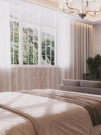 A close-up shot from the bed, focusing on the natural light and the view of the trees outside.