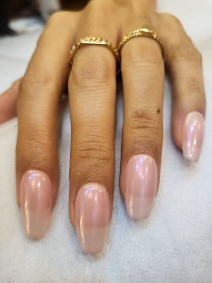 The viral glazed donut look. We achieve this beautiful, iridescent chrome finish over a soft, milky white base for a manicure that is trendy yet timeless.