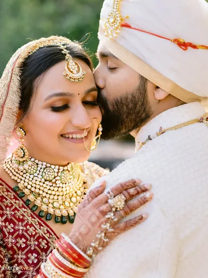 A tender kiss on the forehead, with the winter sun casting a golden glow. This moment at The Leela Palace in Udaipur was a dream Priyal had held for a decade, finally coming true.