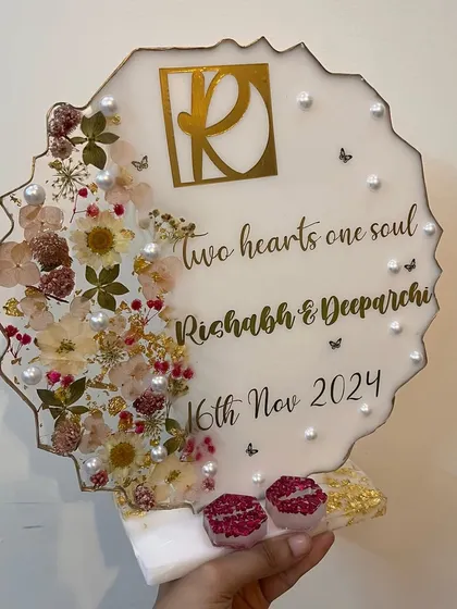 A modern, standing ring platter with a beautiful floral arrangement on one side. The quote 'two hearts one soul' adds a romantic touch.