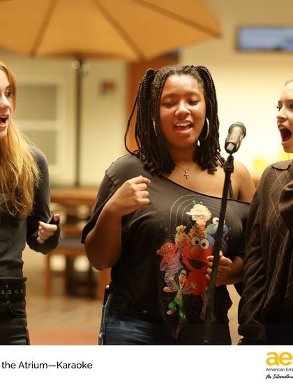 A trio of students harmonizes during their karaoke performance. We love seeing our students collaborate and share their passion for music with the school.