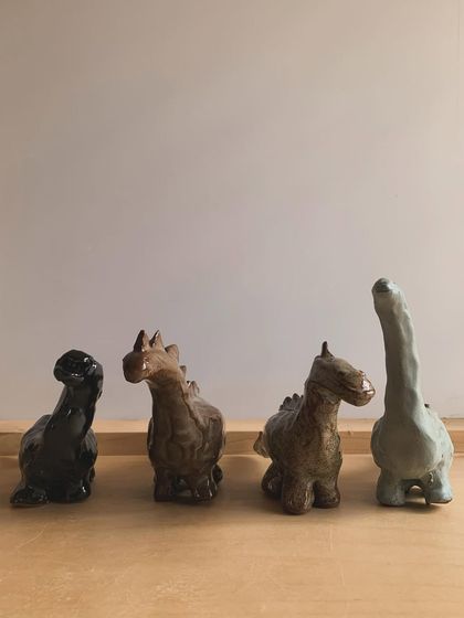 The gang's all here. Four of my miniature dinosaur sculptures, each with its own unique posture and personality.