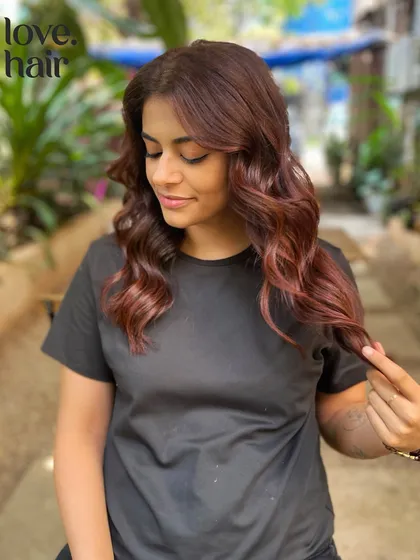 Blue skies and cherry cola floats. A beautiful red-brown balayage that's both warm and vibrant.