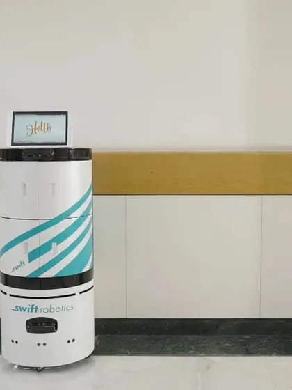 A wide shot of the Swift Robotics unit, establishing its form and design within the hospital environment.