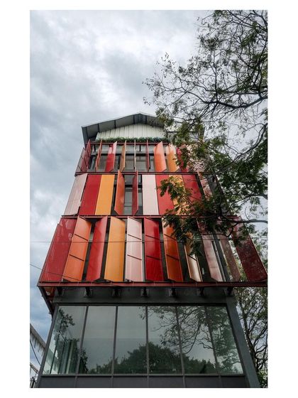The full elevation of the building, showing how the colorful, adjustable panels create a dynamic and ever-changing facade.