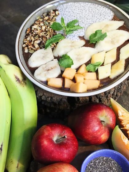 The fresh ingredients that go into our smoothie bowls. We use a variety of seasonal fruits like bananas, apples, and melon to create a nutritious and delicious meal.