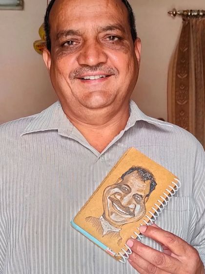My papa holding the custom caricature I drew of him on a notepad. It’s a special feeling to create something for your own family.