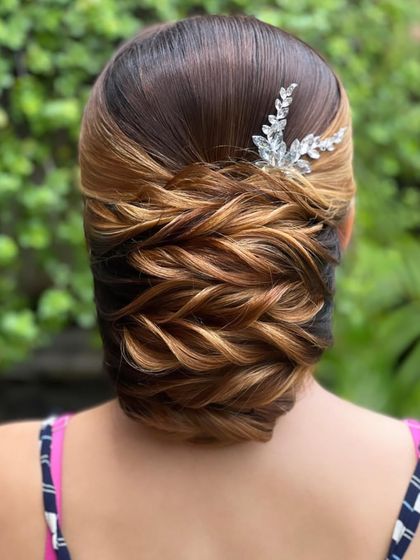 A beautiful traditional low bun with highlighted hair, showing how color can enhance a style.