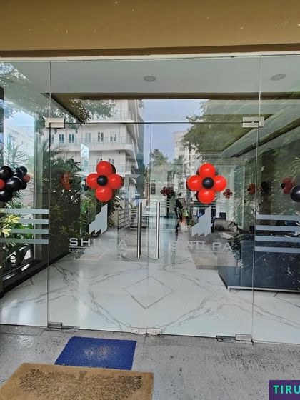 Simple yet effective balloon clusters in red and black, marking the entrance for a themed party.